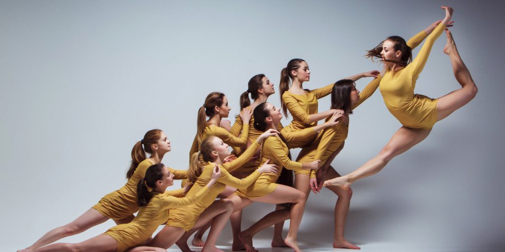 Built By She - The group of modern ballet dancers dancing on gray background