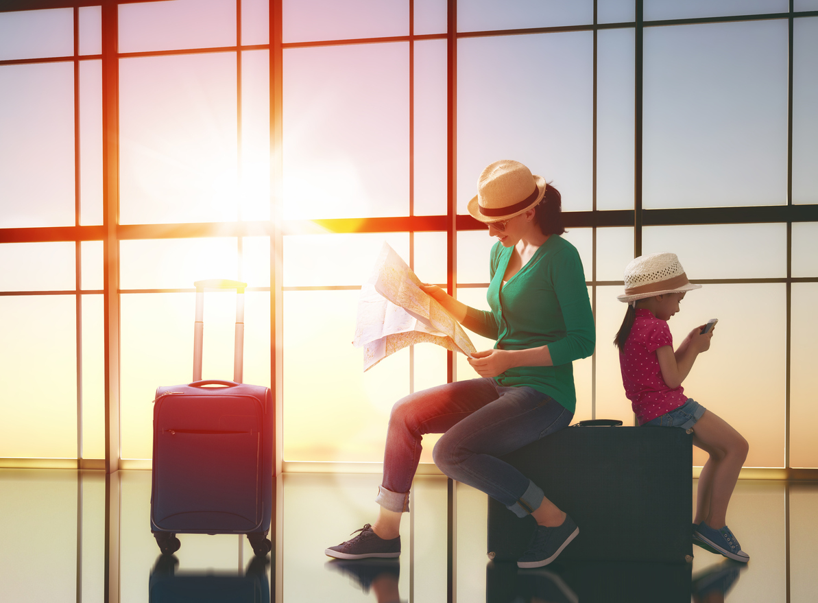 Built By She_Taking Risks_Happy family with suitcases in the airport.